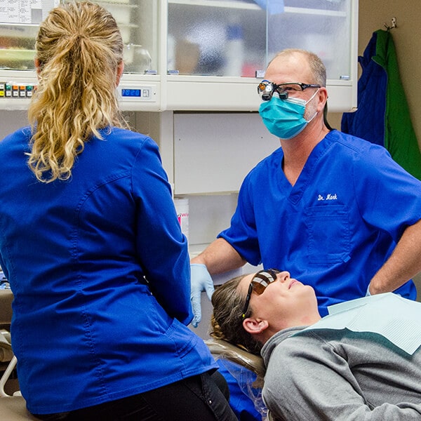 Our two doctors in the dental office with a patient